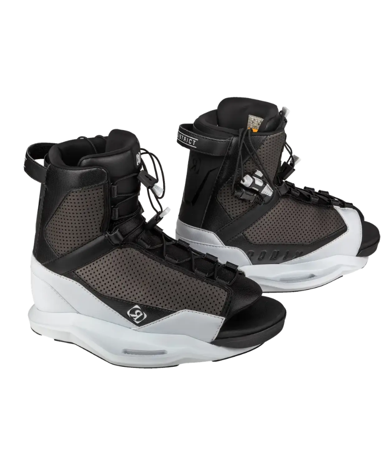 A pair of wakeboard boots in black and dark gray mesh with white soles, shown against a plain white background.