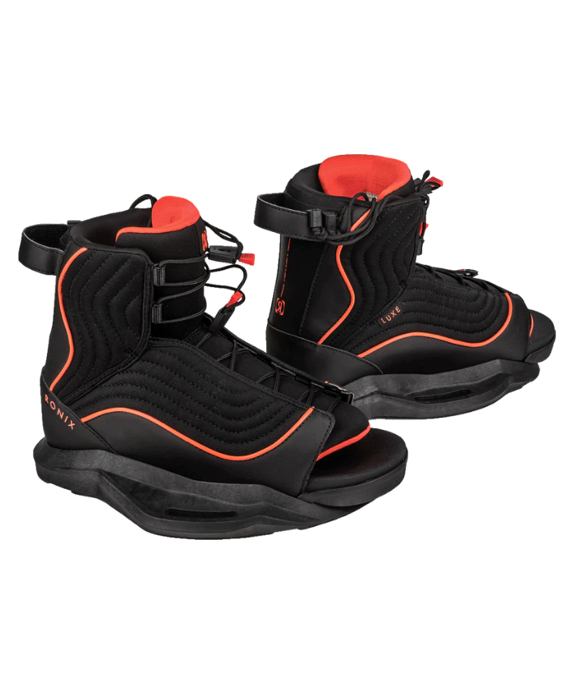 A pair of black wakeboard boots with bright orange-red accents and trim, displayed on a clean white background.